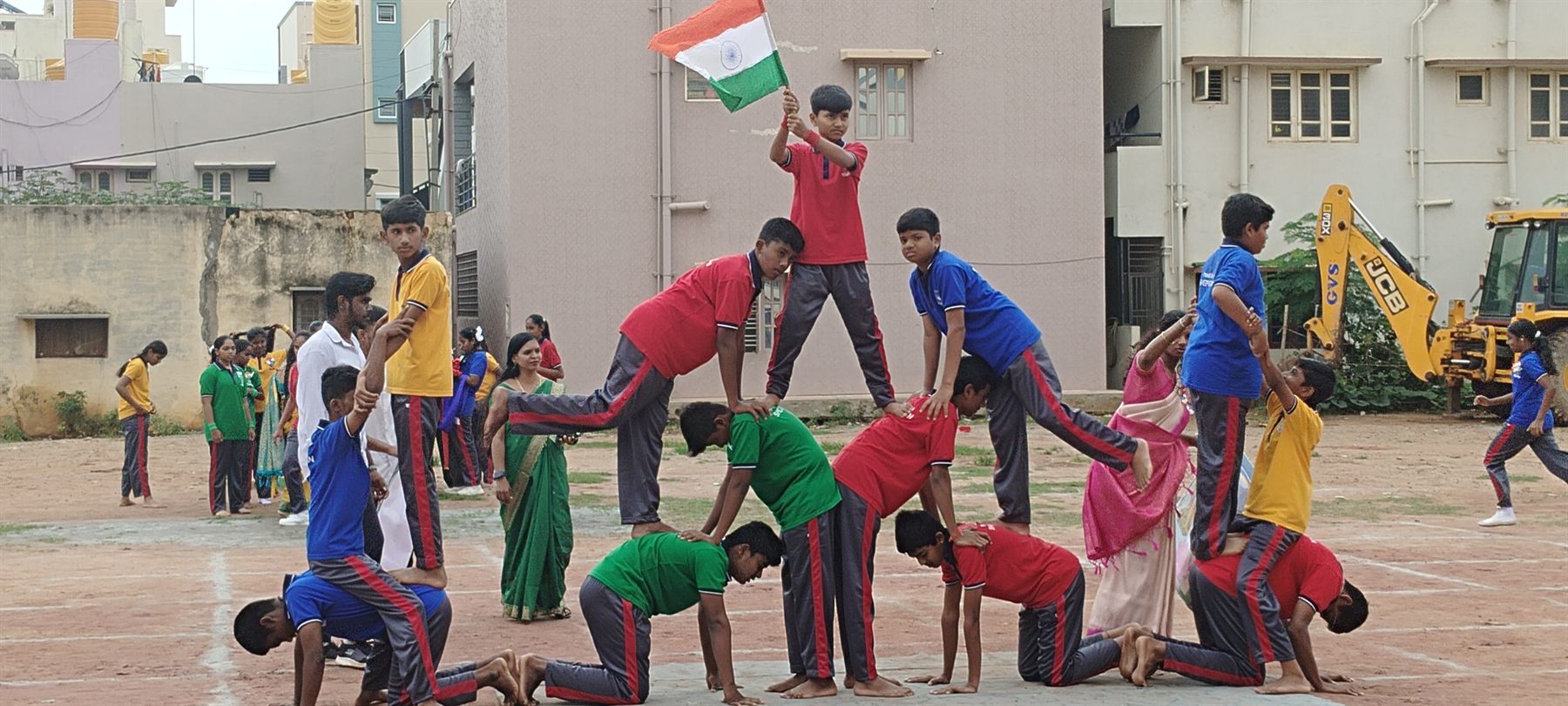 Students performing a human pyramid during sports activities at TS TPS